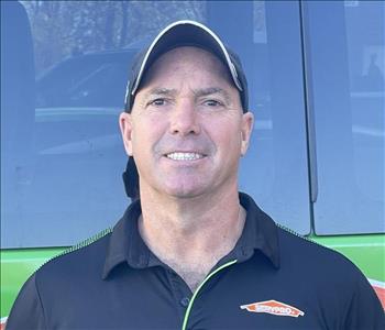 SERVPRO of Levittown Owner, Bill Kelly, standing in front a SERVPRO vehicle.
