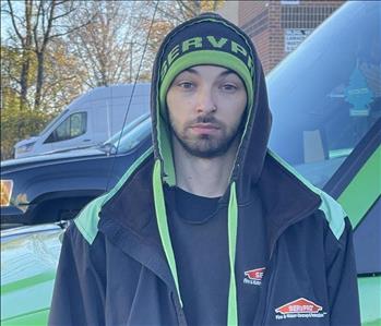 Alex Donaghy, one of our Crew Chiefs, standing in front of one of our SERVPRO vehicles.