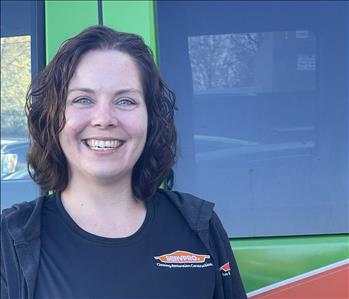 Our Office Manager Wendy standing in front of one of our SERVPRO vehicles.